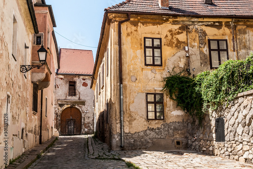 Fototapeta Naklejka Na Ścianę i Meble -  Narrow Alley With Old Buildings In Typical Central European Medieval Town (Bratislava) Slovakia