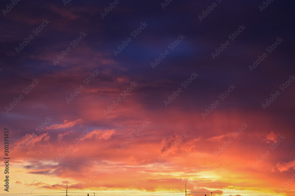 Sunrise. Beautiful clouds in the sky. Color gradient from violet to orange.