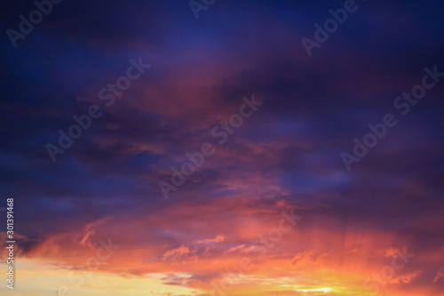 Sunrise. Beautiful clouds in the sky. Color gradient from violet to orange.