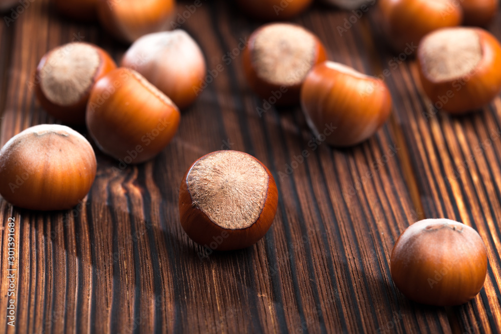 close up of hazelnuts on wooden table . close up of hazelnuts on wooden table .