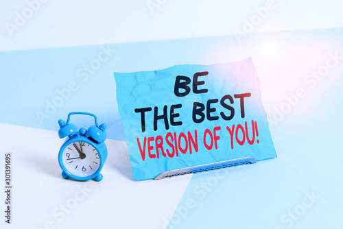 Writing note showing Be The Best Version Of You. Business concept for going to move away from where are start improving Alarm clock beside a Paper sheet placed on pastel backdrop