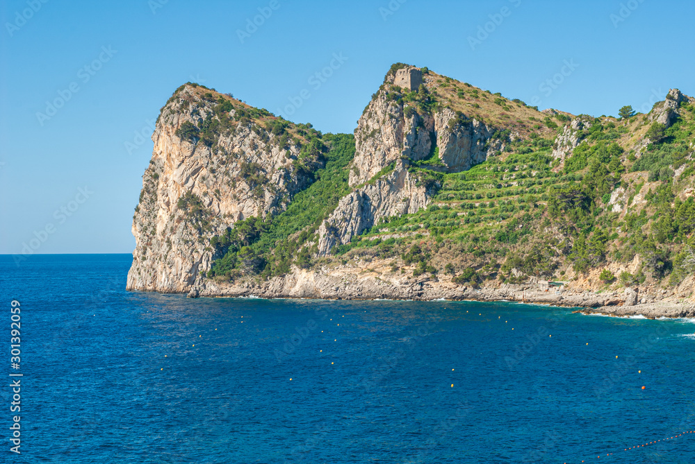 Three mountain laces of the bay of Ieranto, of Massa Lubrense, with the Montalto Tower on the summit, taken from the beach of Nerano, near Sorrento
