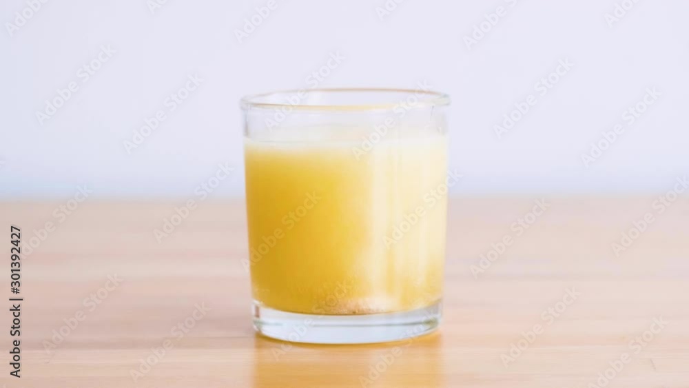 orange vitamin tablet effervescent in a glass with water orange vitamin tablet effervescent in a glass with water