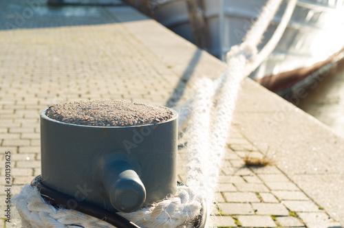 Mooring bollard. Mooring knecht. Ropes photo