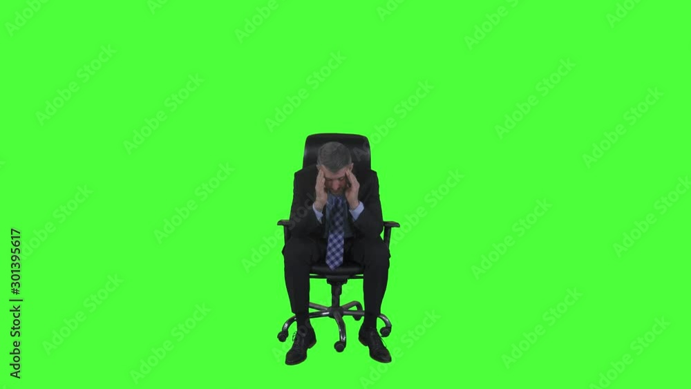 Full length of stressful Caucasian businessman sitting on the office chair in the studio. Shot in 4k resolution with green screen background Full length of stressful Caucasian businessman sitting on the office chair in the studio. Shot in 4k resolution with green screen background