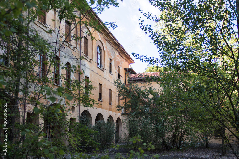 An abandoned seminary surrounded by vegetation