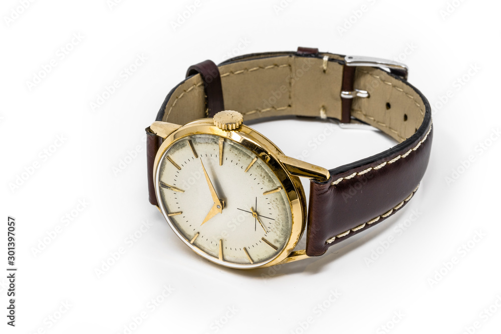 An old gold mechanical wristwatch with manual winding. Antique watch ruined by time, with scratches and mildew stains, rust, oxidation. Leather strap (band). Vintage clock. Spend time. An old gold mechanical wristwatch with manual winding. Antique watch ruined by time, with scratches and mildew stains, rust, oxidation. Leather strap (band). Vintage clock. Spend time.