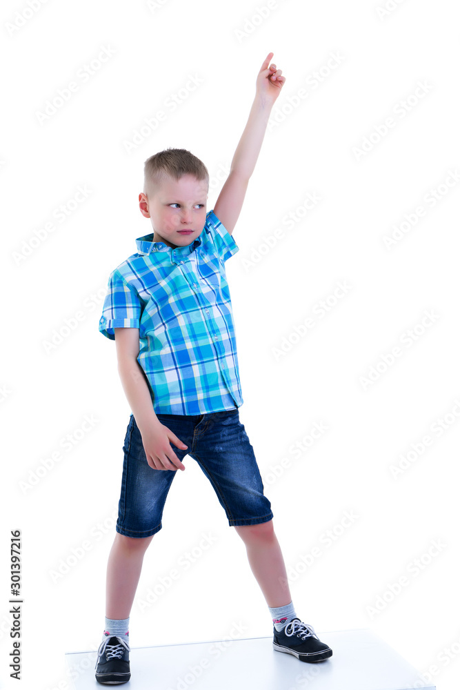 The boy points a finger at something. The boy points a finger at something.