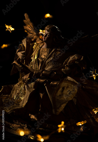 A golden Ambassador fro Christmas, the smoke gold angel isolated captiured with christmas lights 