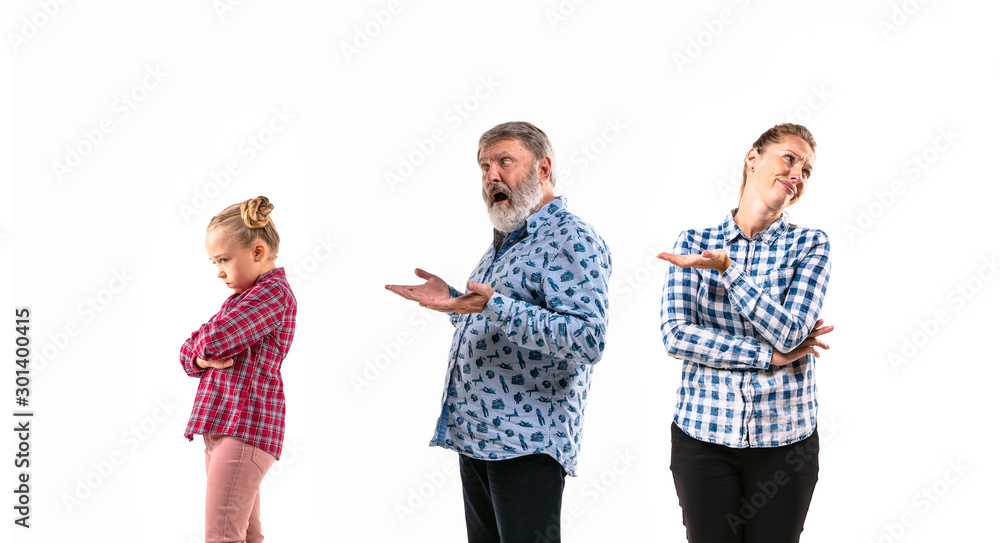 Family members arguing with one another on white studio background. Concept of human emotions, expression, conflict of generations. Woman, man and little girl. Children's grievances, angry grandpa. Family members arguing with one another on white studio background. Concept of human emotions, expression, conflict of generations. Woman, man and little girl. Children's grievances, angry grandpa.