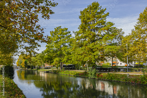 Beautiful autumn views of Canal du Midi (in XVII century - Royal Canal in Languedoc) in Toulouse and trees reflection in water. Toulouse, Haute-Garonne, France.