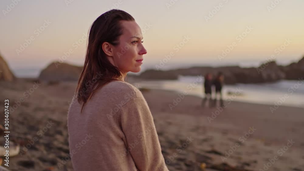 Woman enjoying sunset near ocean Woman enjoying sunset near ocean
