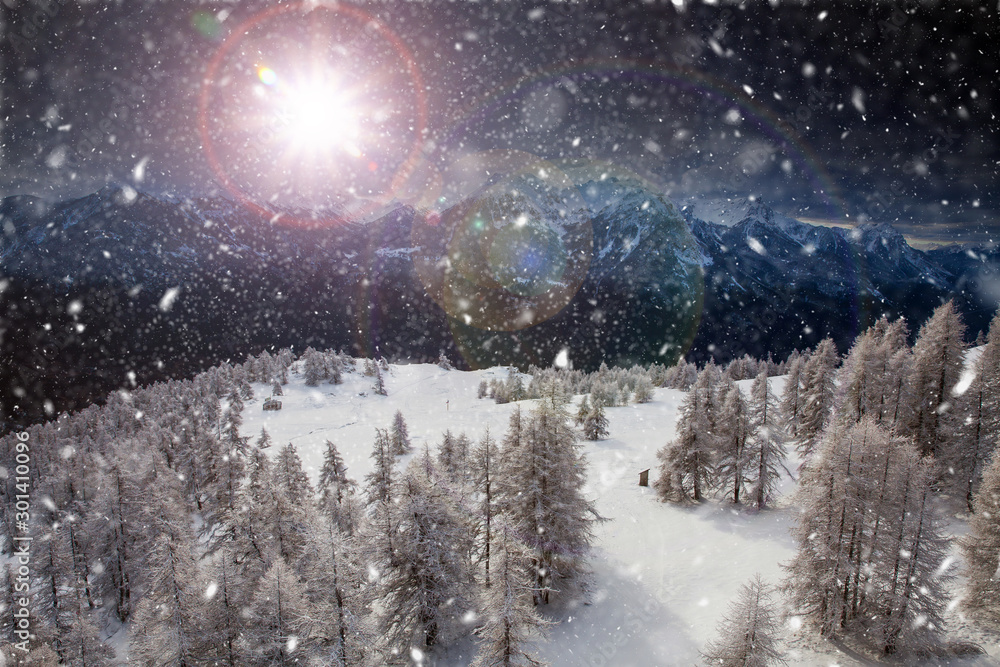 Fototapeta premium Christmas background with snowy fir trees and mountains in heavy blizzard.