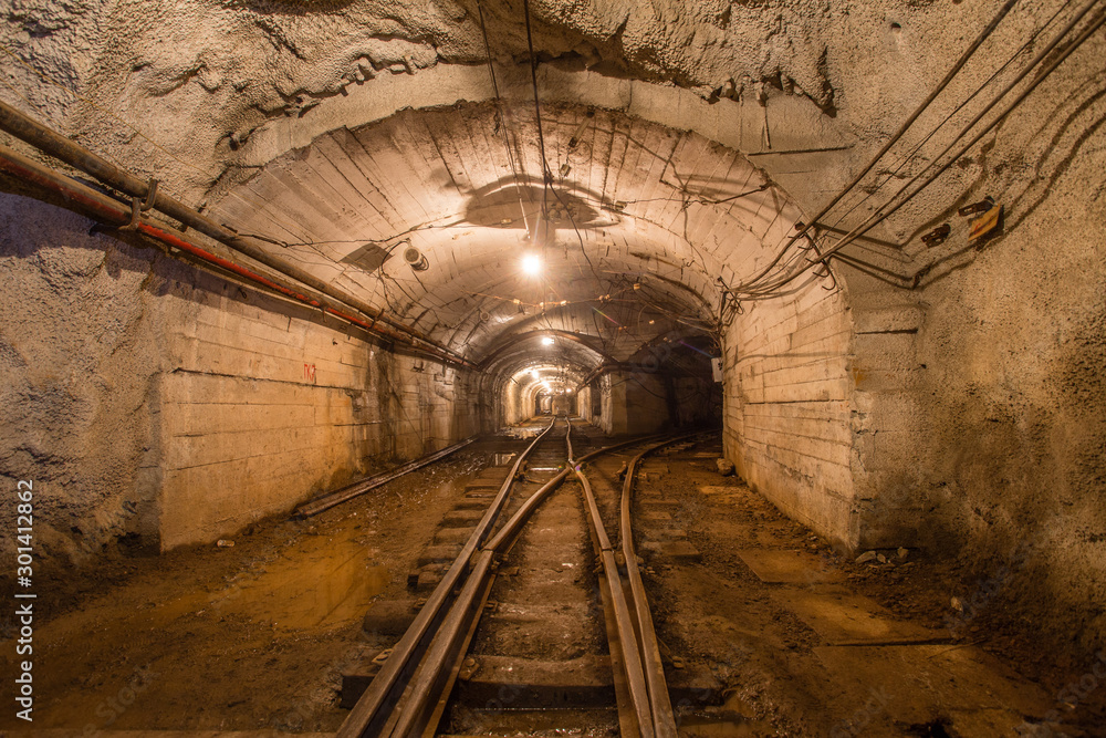 Fototapeta Gold iron mine ore shaft tunnel drift with rails underground