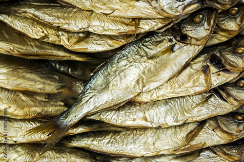 smoked fish is on the counter in the store or in the market. Background © OlegDoroshin