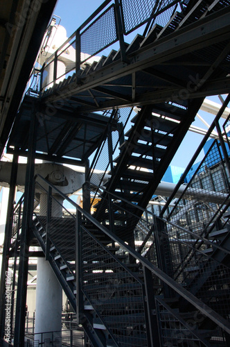 lots of metal stairways construction against blue sky background