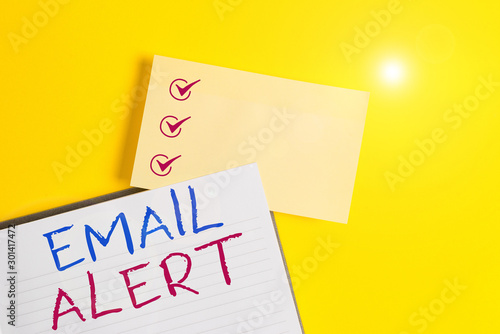 Conceptual hand writing showing Email Alert. Concept meaning emails auto generated nd sent to designated recipients Empty orange paper with copy space on the yellow table