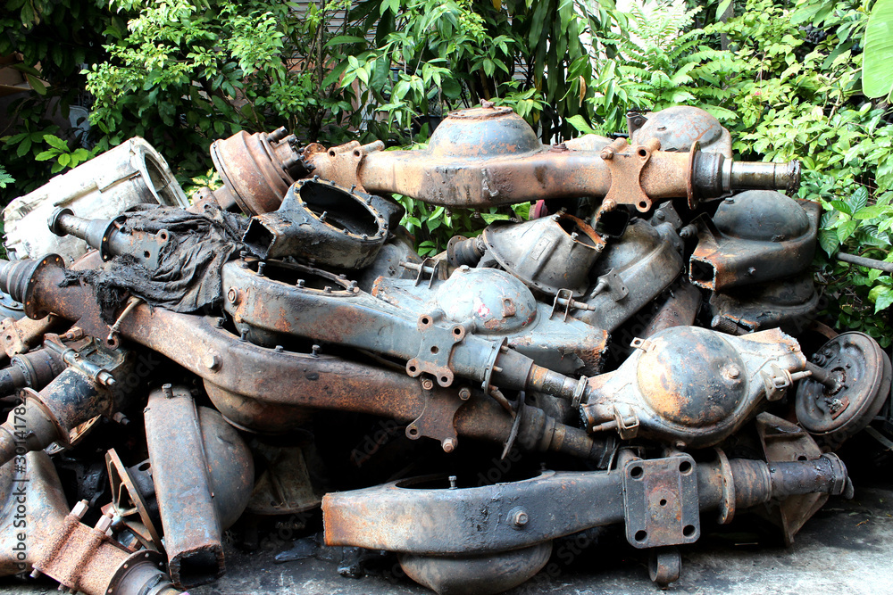 A pile of old rusty axle housings