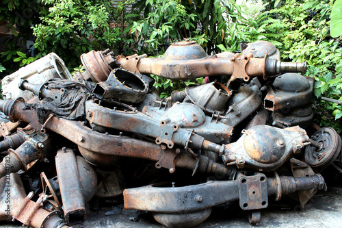A pile of old rusty axle housings