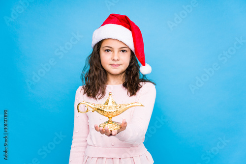 Little girl asking for a desiree celebrating christmas day photo