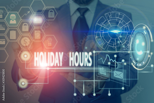 Writing note showing Holiday Hours. Business concept for employee receives twice their normal pay for all hours Picture photo network scheme with modern smart device