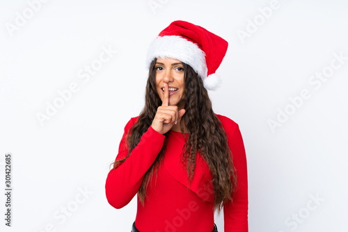 Girl with christmas hat over isolated white background doing silence gesture