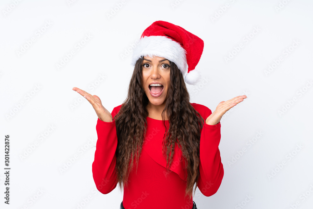 Girl with christmas hat over isolated white background with surprise facial expression Girl with christmas hat over isolated white background with surprise facial expression