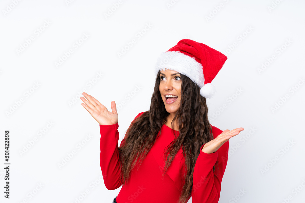Girl with christmas hat over isolated white background with surprise facial expression Girl with christmas hat over isolated white background with surprise facial expression