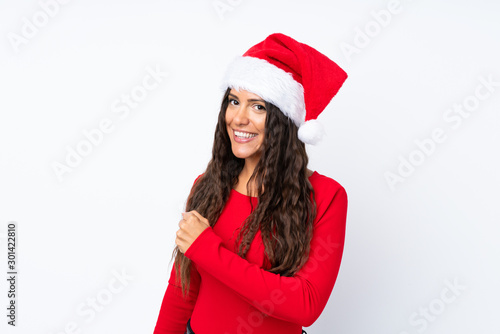 Girl with christmas hat over isolated white background celebrating a victory