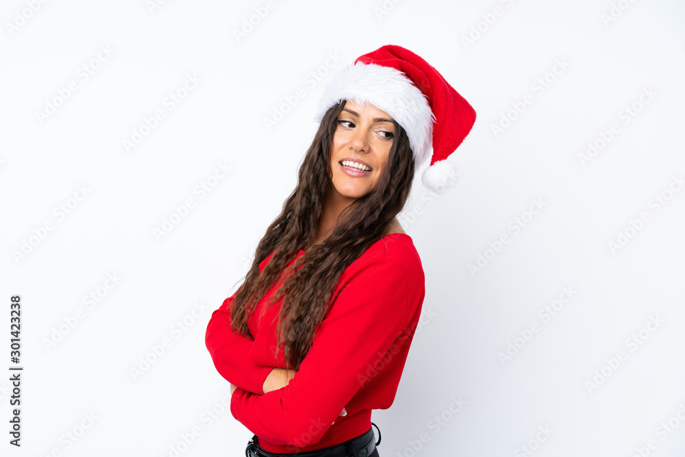 Girl with christmas hat over isolated white background laughing