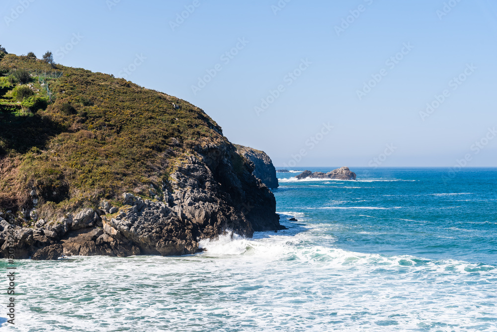 Scenic view of sea against blue sky in rocky coast Scenic view of sea against blue sky in rocky coast