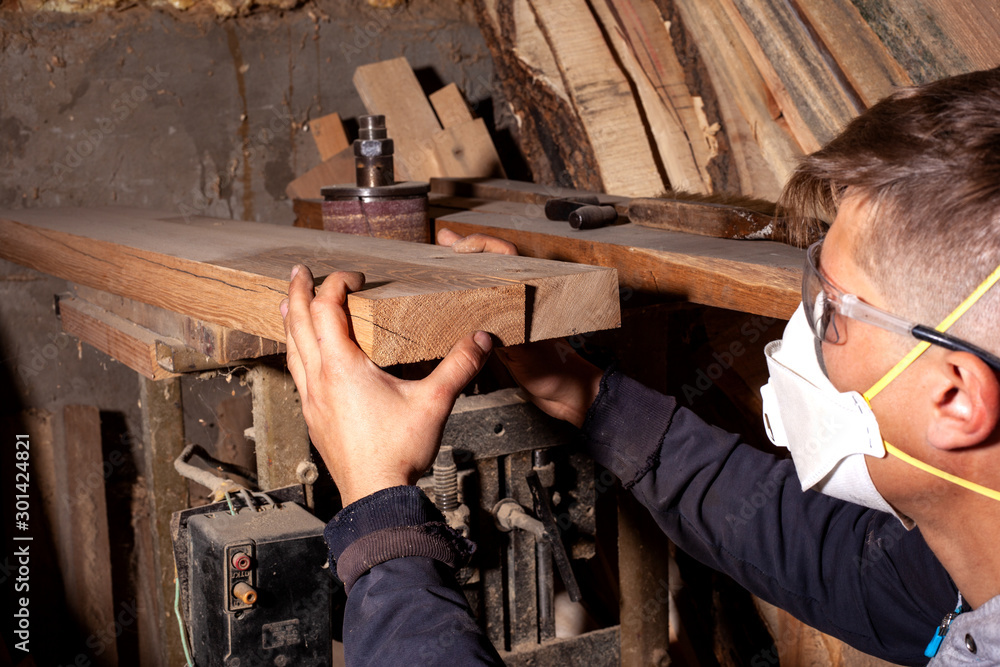 wood worker selects flat boards for the manufacture of wood products,carpenter artisan checks the quality of wooden workpieces wood worker selects flat boards for the manufacture of wood products,carpenter artisan checks the quality of wooden workpieces