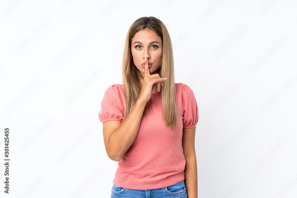 Young blonde woman over isolated white background showing a sign of silence gesture putting finger in mouth