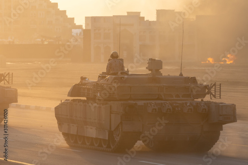 Military army tank vehicles driving down the road with guns and military personel aiming and shooting. Military and war concept of power, force, strength.