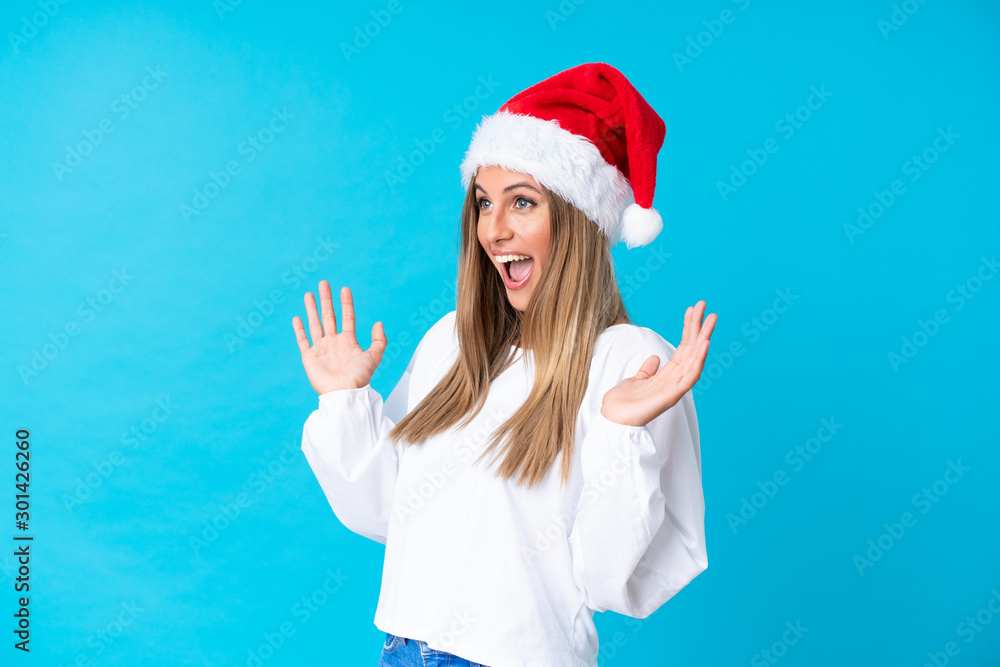 Girl with christmas hat over isolated background with surprise facial expression Girl with christmas hat over isolated background with surprise facial expression