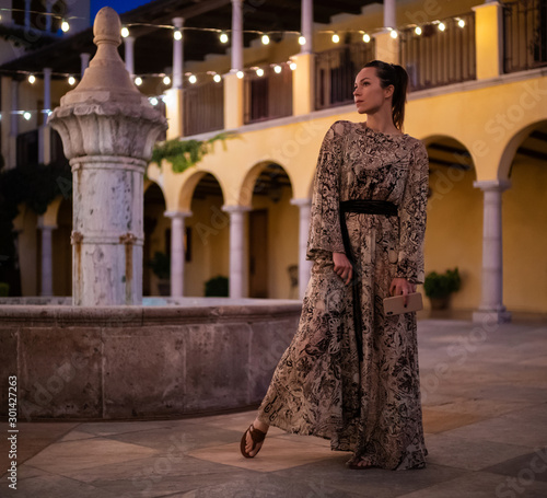 Lady in beautiful dress posing near fountain