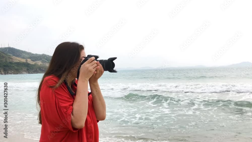 Beautiful model with swimsuit at beach photographing. Tracking shot in slow Beautiful model with swimsuit at beach photographing. Tracking shot in slow