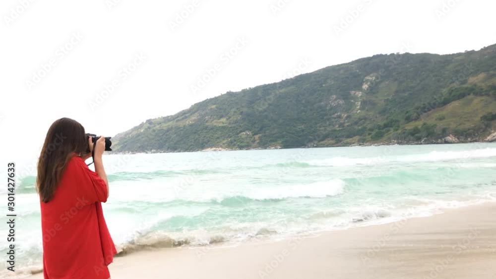 Beautiful model with swimsuit at beach photographing. Tracking shot Beautiful model with swimsuit at beach photographing. Tracking shot