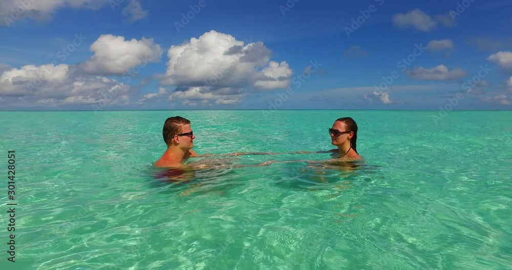 Tourists Couple Having Fun on the Beautiful Crytal Clean Water and Cloudy Blue Sky in Europe - Close-up Shot Tourists Couple Having Fun on the Beautiful Crytal Clean Water and Cloudy Blue Sky in Europe - Close-up Shot