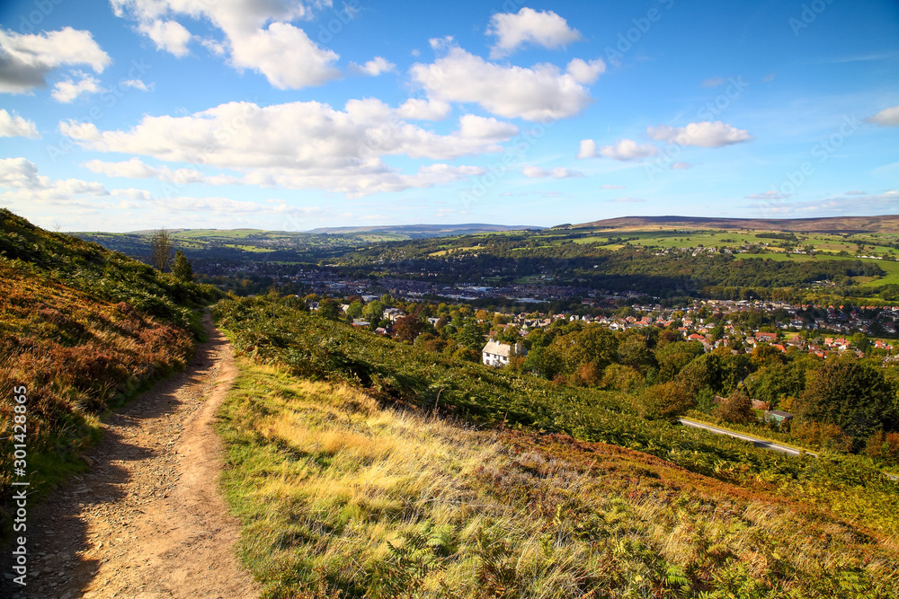 Path running along ilkley moor and a view of ilkley town