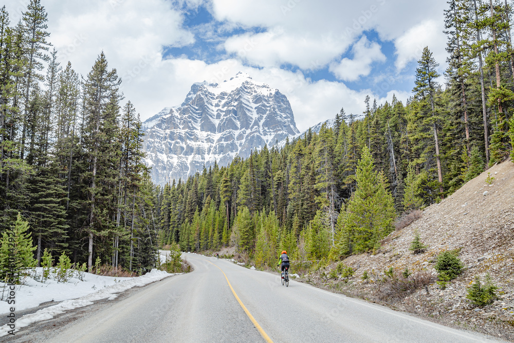 Cyclist on Bow Valley Parkway in Banff, Canada Cyclist on Bow Valley Parkway in Banff, Canada