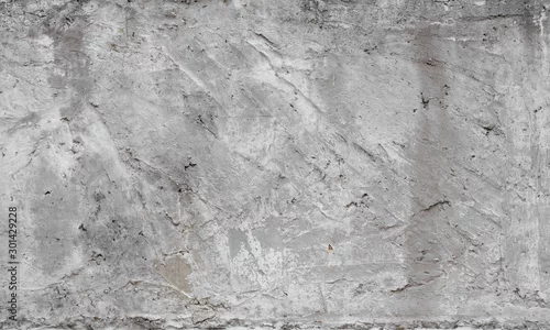Obraz Tekstura stara betonowa ściana dla tła. Tło białe ściany betonowe z pęknięcia i dziury.