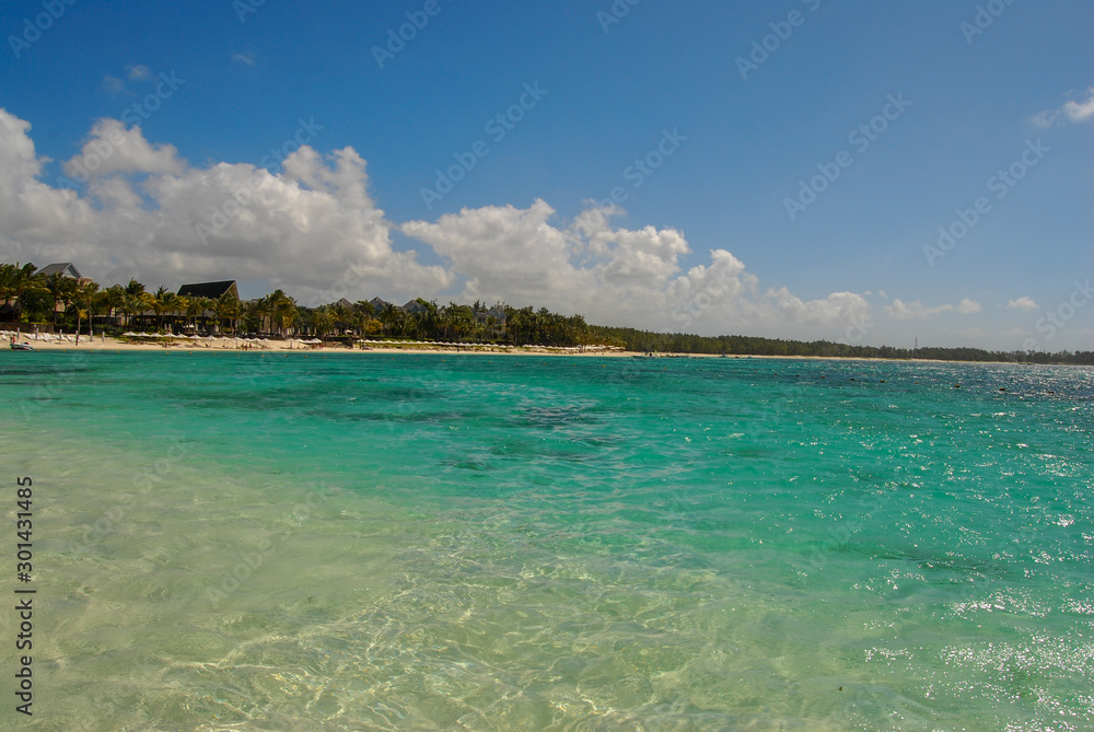 view of tropical beach with blue sky and clouds view of tropical beach with blue sky and clouds
