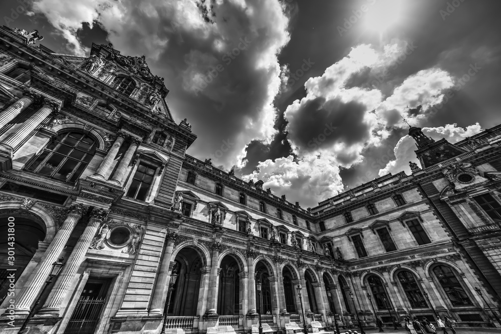 Dramatic sky over world famous Louvre Museum in black and white