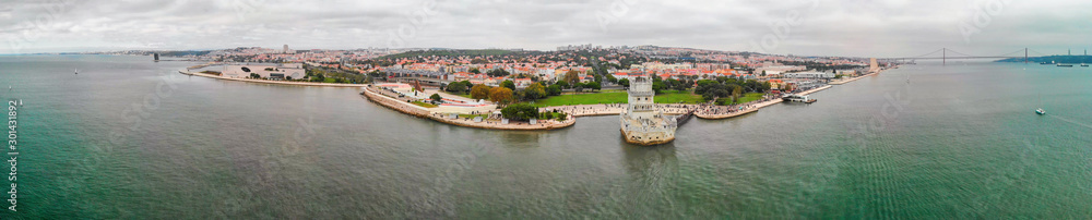 Amazing panoramic aerial view of Lisbon from drone. Belem Tower and city skyline at sunset