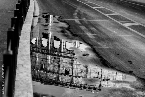 World famous Coliseum reflected in a puddle photo