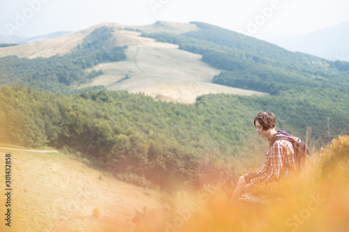 Boy with backpack in beauty autumn mountains . Travel concept. Landscape photography