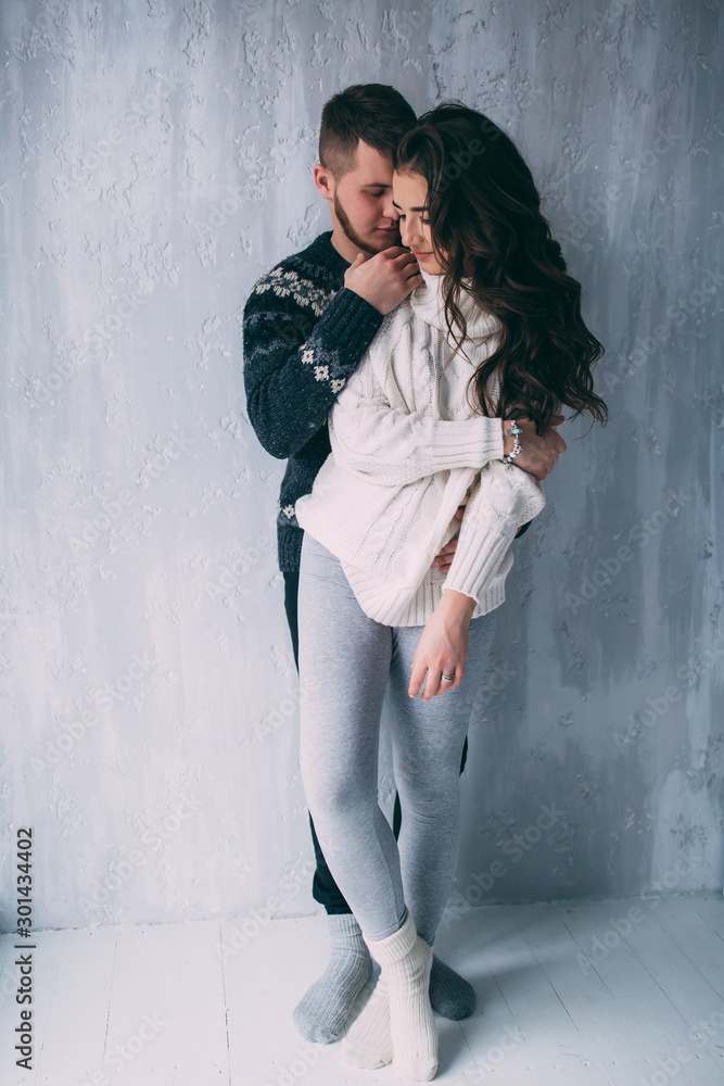 Romantic photo session of a young couple. Meeting a guy and a girl. The guy hugs his girlfriend.