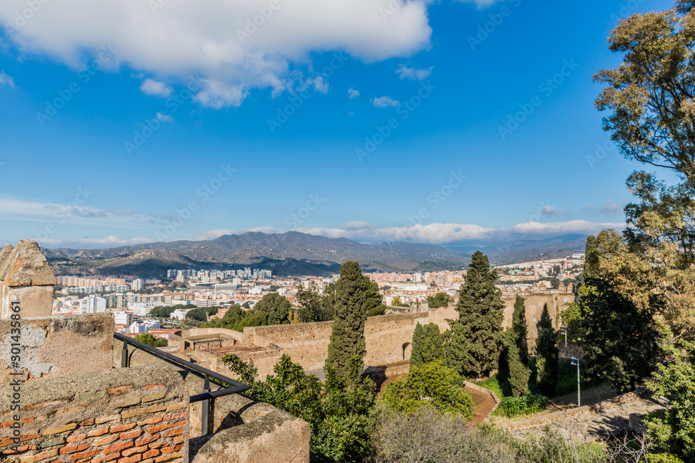 Part of the city of Malaga with mountains in the background seen from the Alcazaba, sunny day with a blue sky in the province of Malaga, Spain