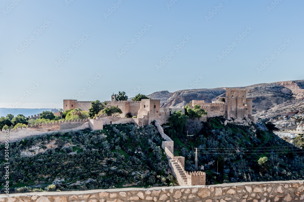 Rocky hill with the walls and the Alcazaba in the background in Almeria Spain